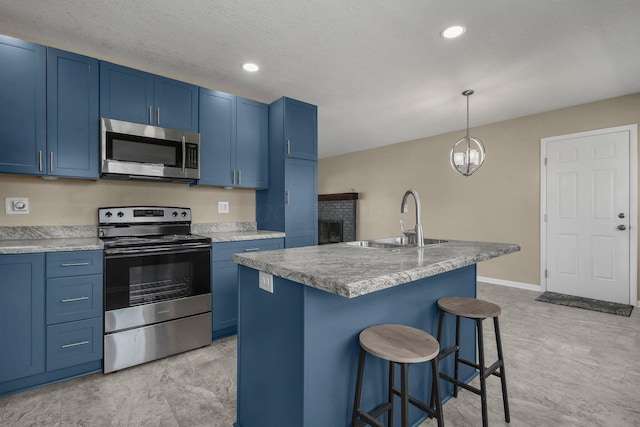 kitchen featuring blue cabinetry, stainless steel appliances, and a sink