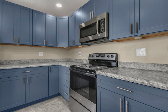 kitchen with blue cabinetry and appliances with stainless steel finishes