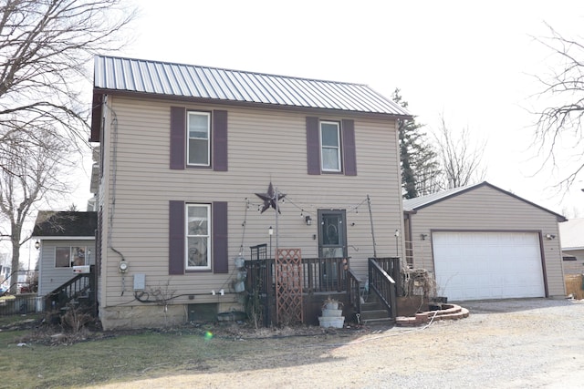 view of front facade featuring metal roof, a garage, and dirt driveway