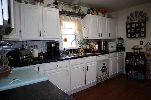 kitchen featuring a sink, backsplash, dishwasher, and white cabinetry