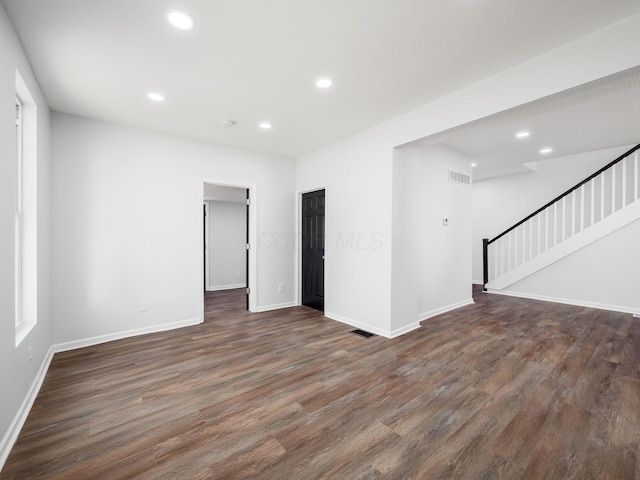 spare room featuring stairway, recessed lighting, and wood finished floors