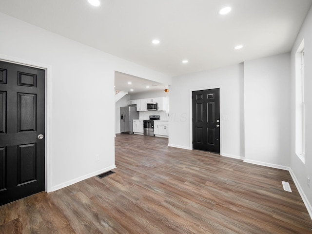 foyer entrance with recessed lighting, visible vents, baseboards, and wood finished floors