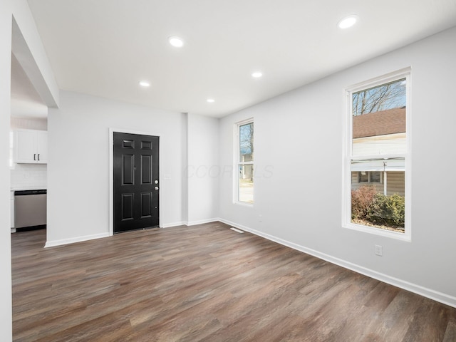 unfurnished room with recessed lighting, baseboards, plenty of natural light, and wood finished floors