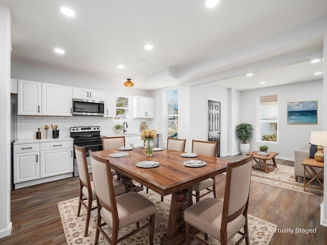 dining space featuring recessed lighting, baseboards, and dark wood finished floors