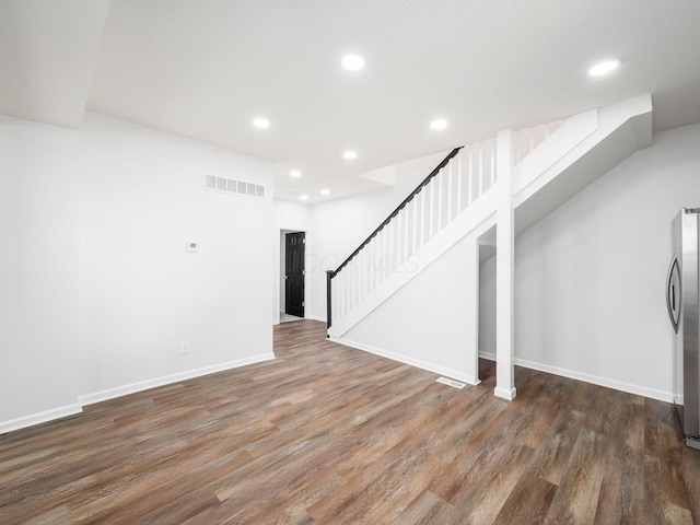 basement with stairs, recessed lighting, wood finished floors, and visible vents