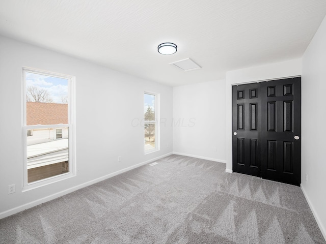 carpeted spare room with baseboards