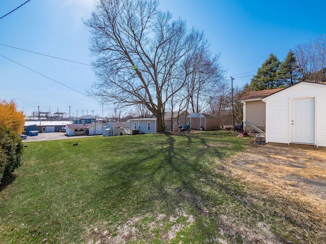 view of yard featuring a storage shed and an outdoor structure