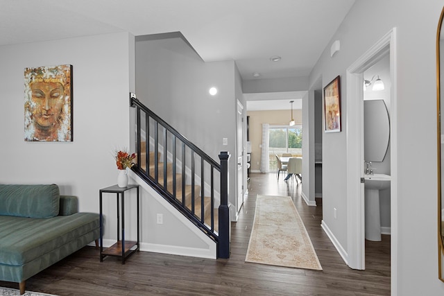 interior space featuring stairway, baseboards, and dark wood-type flooring