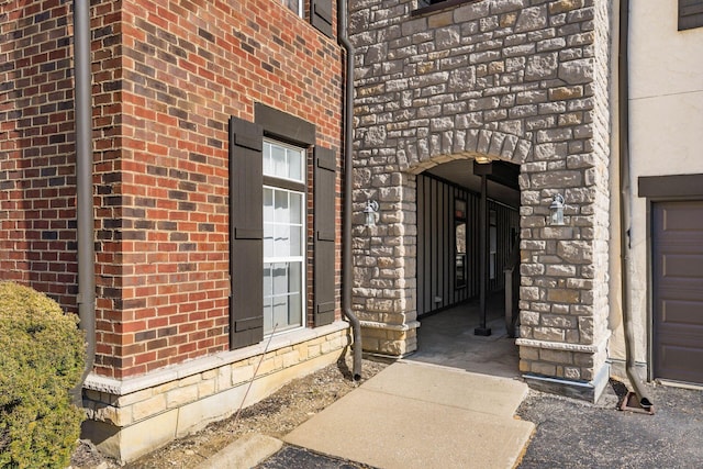 view of exterior entry with brick siding