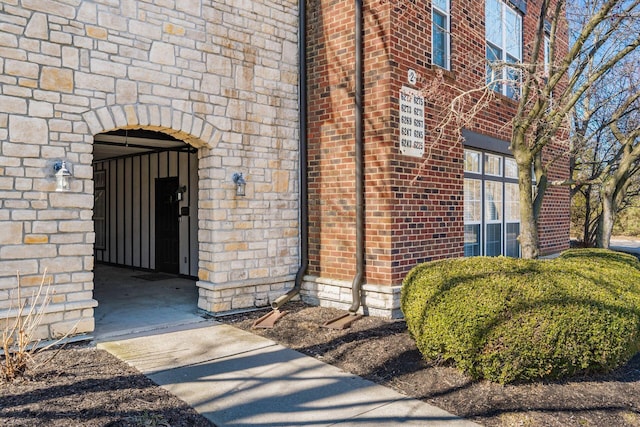 entrance to property featuring brick siding