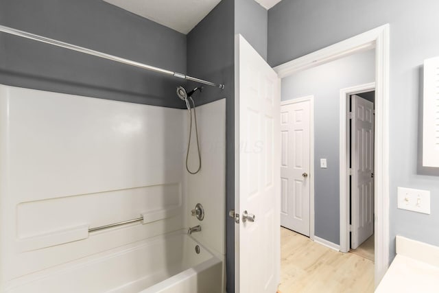 bathroom with shower / tub combination and wood finished floors