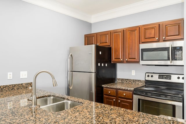 kitchen featuring appliances with stainless steel finishes, dark stone counters, crown molding, and a sink