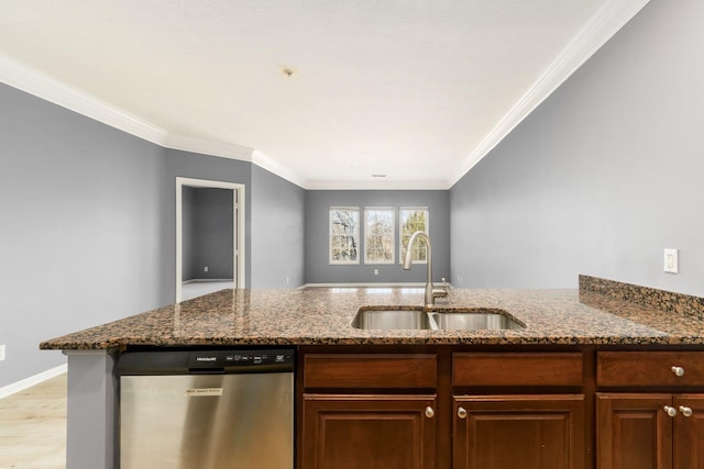 kitchen with light wood finished floors, dark stone counters, a sink, dishwasher, and crown molding