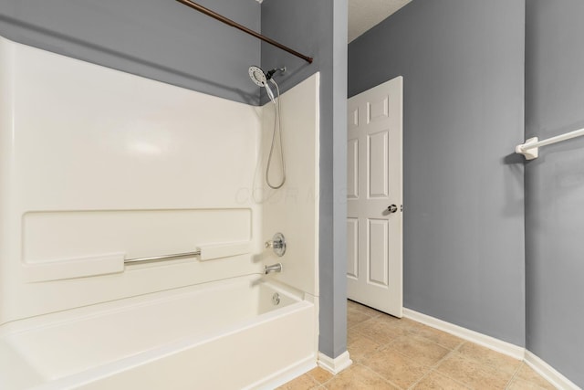 bathroom featuring tile patterned flooring, bathtub / shower combination, and baseboards