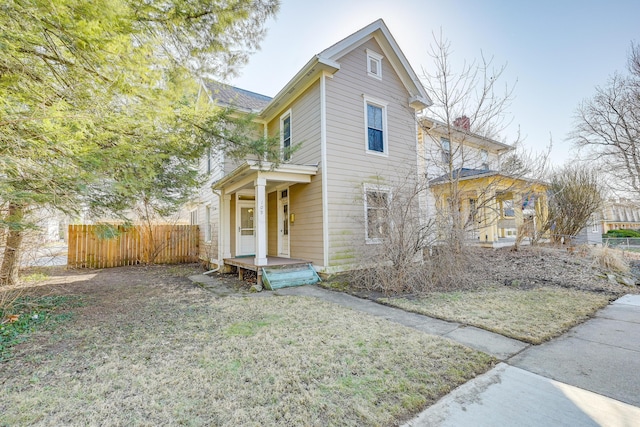 traditional-style house featuring fence