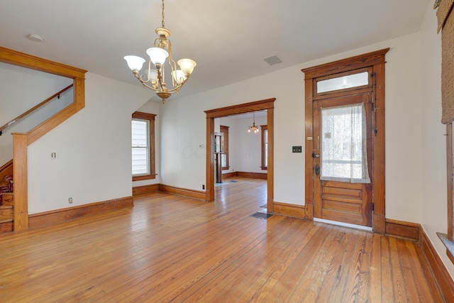 entryway with a chandelier, visible vents, and plenty of natural light