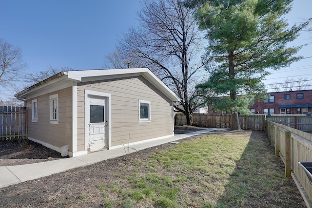 exterior space with an outdoor structure and a fenced backyard