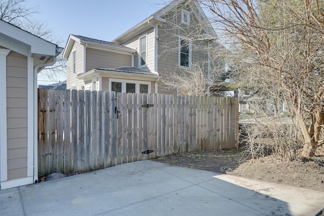 view of side of home featuring a patio area and fence