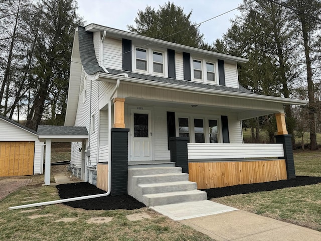 view of front of property with a porch and roof with shingles