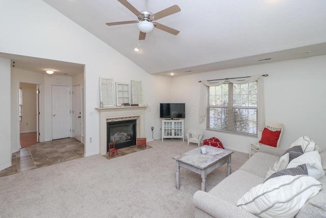 tiled living area with carpet floors, a ceiling fan, baseboards, and a high end fireplace