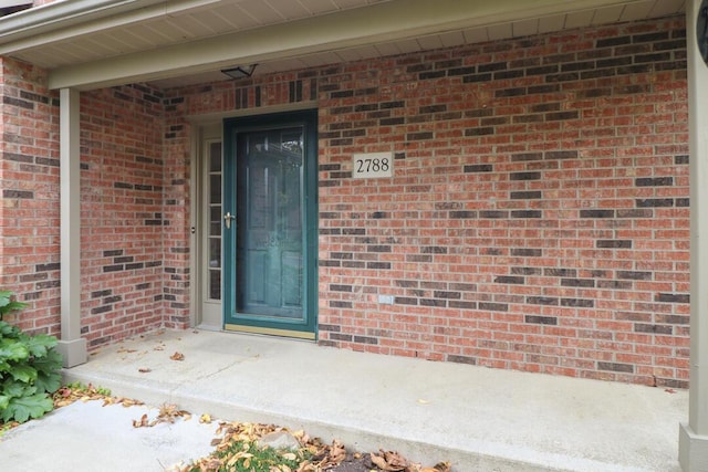 property entrance with brick siding