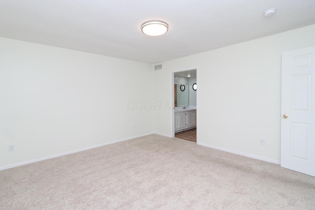carpeted empty room with baseboards and visible vents