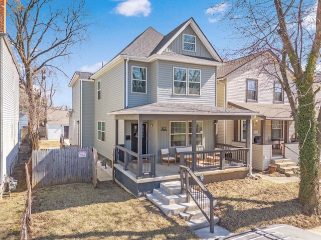 view of front of home featuring a porch, fence, board and batten siding, and roof with shingles