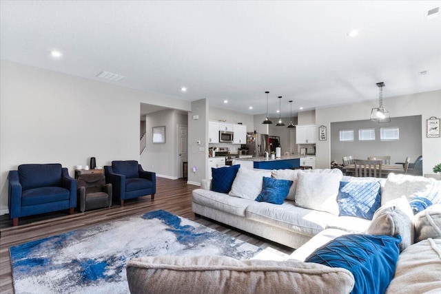 living room with recessed lighting, visible vents, baseboards, and dark wood-style flooring