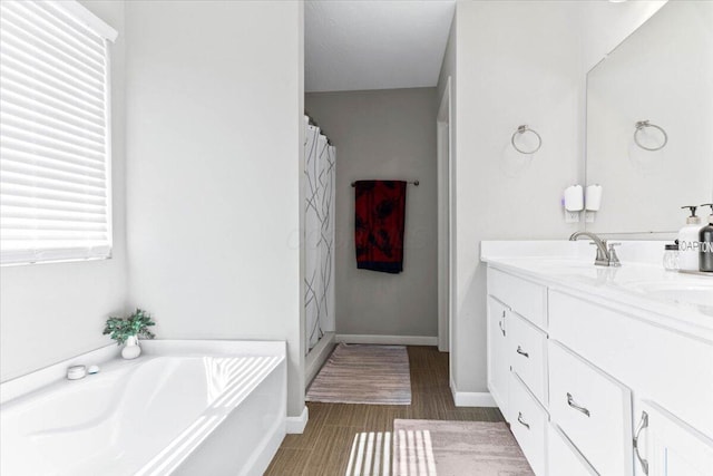 full bathroom with a shower with shower curtain, baseboards, a bath, and vanity