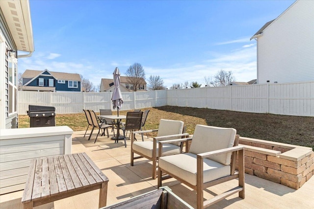 view of patio / terrace featuring outdoor dining area, a grill, and a fenced backyard