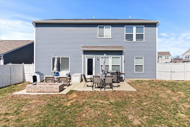 rear view of house with a lawn, a fenced backyard, and a patio area