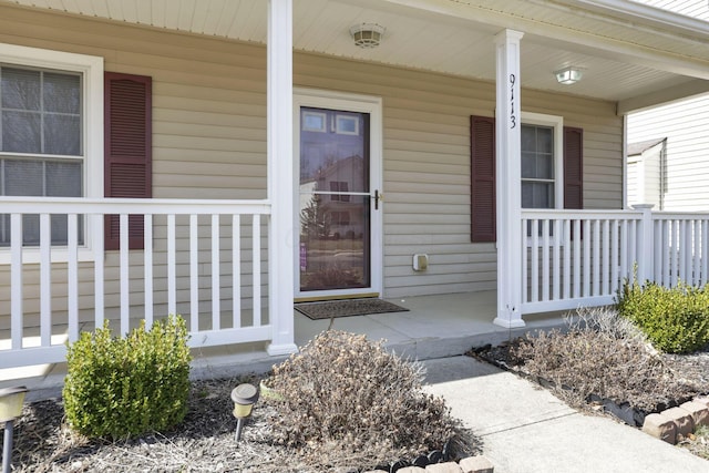 view of exterior entry with a porch