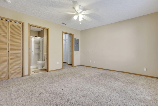 unfurnished bedroom featuring electric panel, visible vents, carpet floors, and a textured ceiling