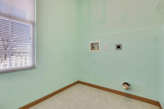 clothes washing area with baseboards, light floors, washer hookup, laundry area, and electric dryer hookup