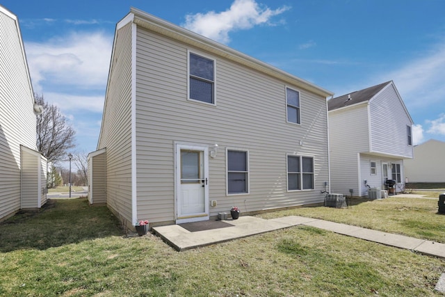 rear view of property featuring a patio area, cooling unit, and a yard