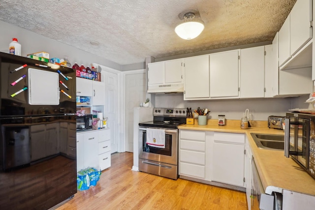 kitchen with light countertops, under cabinet range hood, electric range, light wood-style flooring, and black microwave