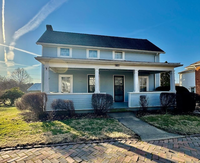 view of front of house featuring covered porch and a chimney