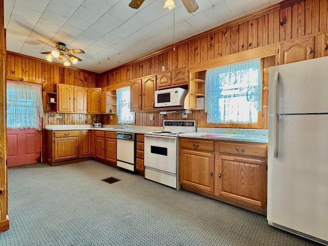 kitchen featuring wooden walls, ornamental molding, white appliances, a ceiling fan, and open shelves