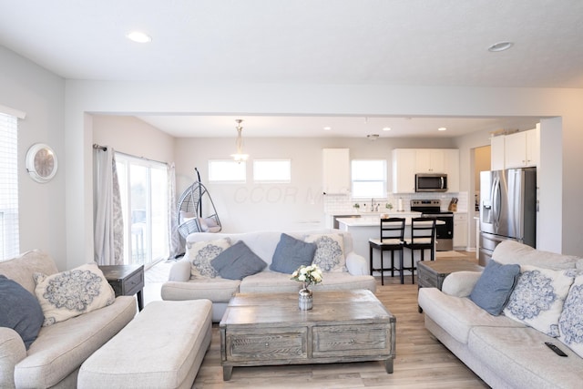 living area featuring recessed lighting and light wood-type flooring