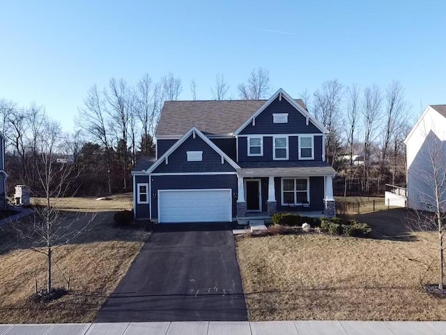 view of front of property featuring covered porch, driveway, and a front yard