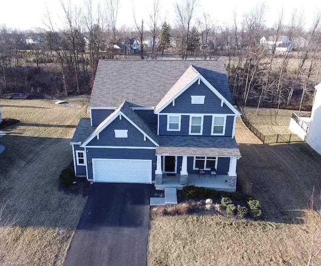 view of front of house with a porch, an attached garage, and aphalt driveway