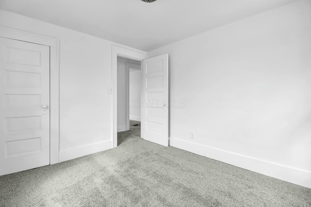 unfurnished bedroom featuring baseboards and carpet floors