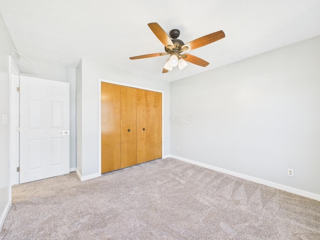 unfurnished bedroom with a closet, ceiling fan, baseboards, and carpet