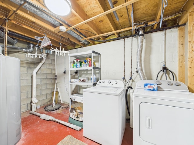 clothes washing area with water heater, laundry area, and washing machine and dryer