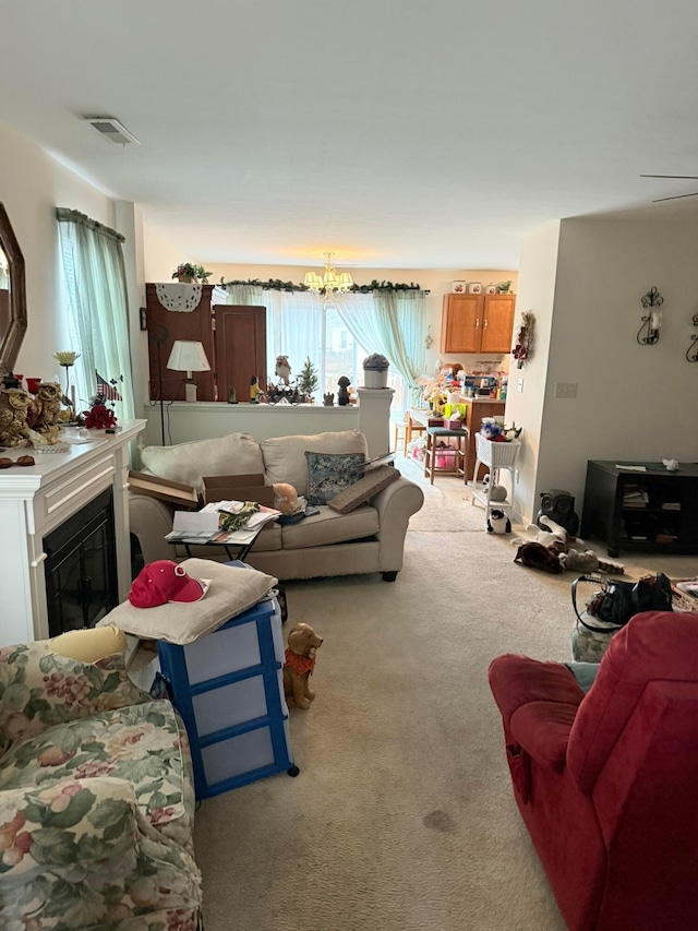 carpeted living room with a glass covered fireplace and visible vents