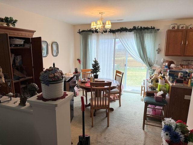 dining area featuring light carpet and a notable chandelier