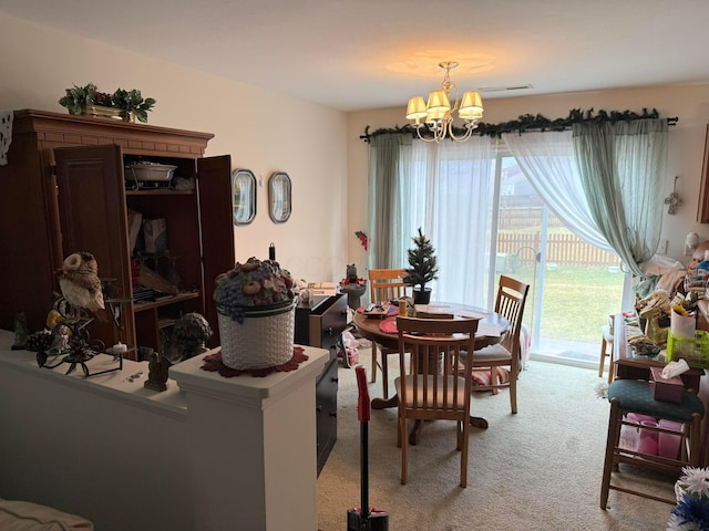 dining area with light colored carpet, visible vents, a wealth of natural light, and a chandelier