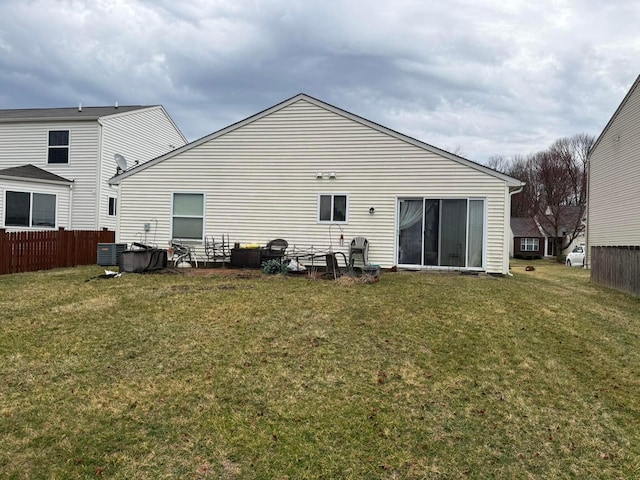 back of house featuring a yard and fence