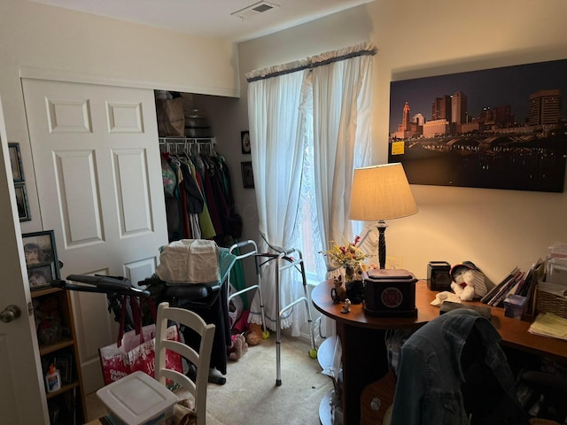 carpeted bedroom with a closet, visible vents, and multiple windows