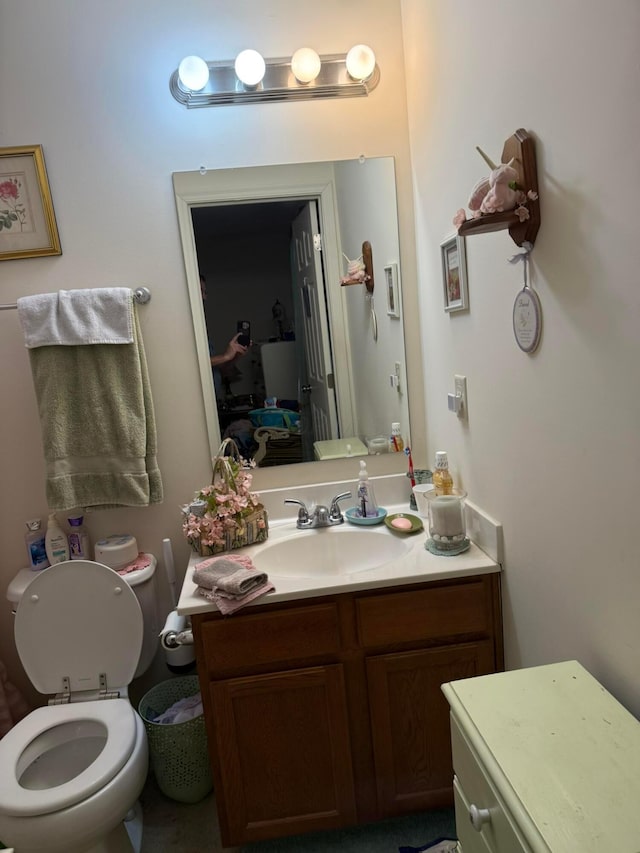 bathroom featuring toilet and vanity